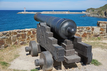 Old iron cannon pointing at the sea in the harbor of Port-Vendres, Mediterrean, Cote Vermeille, Roussillon, Pyrenees Orientales, south of France