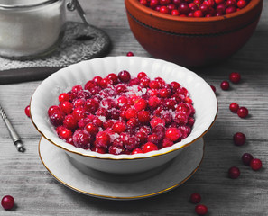 Cranberries (Lingonberry, cowberries) on light wooden background.