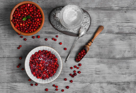 Cranberries (Lingonberry, cowberries) on light wooden background.