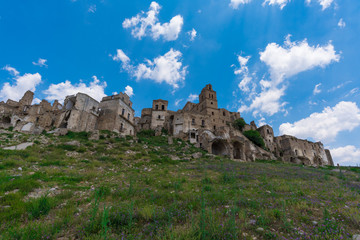 Craco (Italy) - The evocative ruins and landscapes of the ghost town scattered among the badlands hills of the Basilicata region, beside Matera, destroyed by a landslide and abandoned.