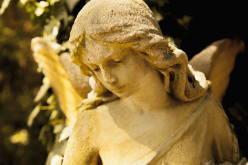 gold angel in the sunlight (antique statue)