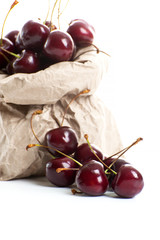 Berries of ripe red cherries close-up on a clean white background..