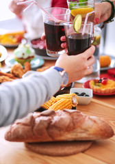 Top view of group of people having dinner together while sitting at wooden table. Food on the table. People eat fast food.