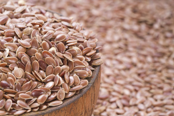 Flax seeds in wooden bowl and spoon