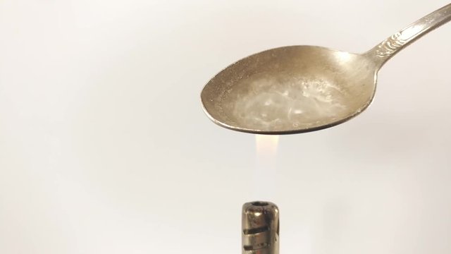 Man Preparing Dose Of cocaine by heating it with lighter in spoon.  Close up. Footage will work great for any videos dealing with opiate addiction, Life Danger, crime.
