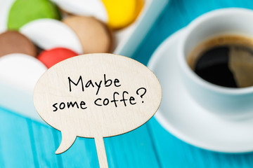 Board with inscription, macaroons ,coffee