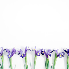 Beautiful purple iris flowers on white background. Flat lay, top view.