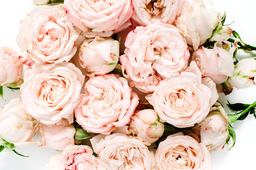 Beige rose buds bouquet on white background. Flat lay, top view.