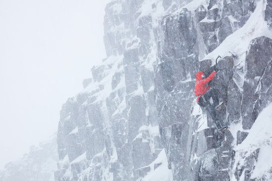 Climber soloing in winter blizzard