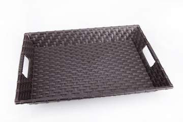 Empty brown plastic tray on a white surface. Plastic tray isolated on white background.