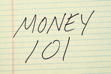 The words "Money 101" on a yellow legal pad