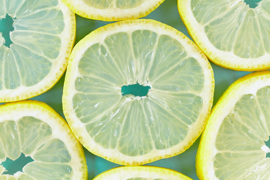 Fresh lemon slices on light blue background