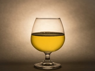 Glass with cool of beer isolated on dark tone in background