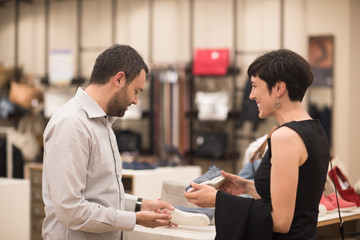 couple chooses shoes At Shoe Store