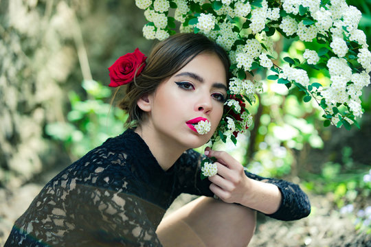 pretty girl with fashionable spanish makeup, rose flower in hair