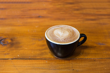 latte art coffee on wood table