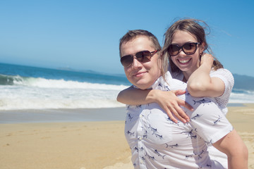 Young romantic couple hugging on the beach