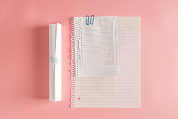 Papers of assorted sizes on a pink background