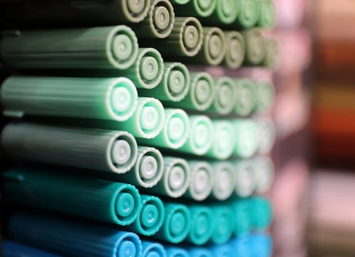 Lined up color marker art supplies dark hues