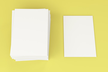 Stack of blank white closed brochure mock-up on yellow background