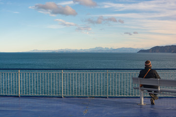 A lonely person looking at the sea