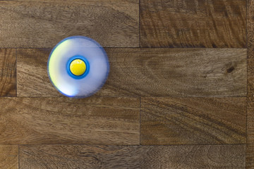 Play Fidget spinner spinning on wood background With Light