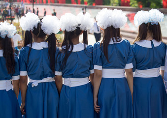 Choir of girls with white bows on head