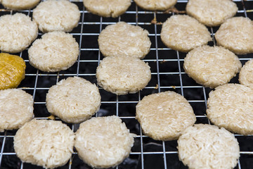 Grilled sticky rice with egg on the charcoal stove, local food of Northeastern Thailand and Laos