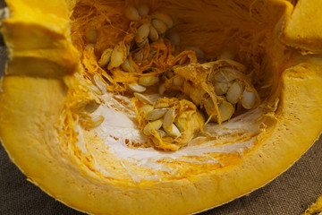 Pieces of cut pumpkin together with pumpkin seeds.