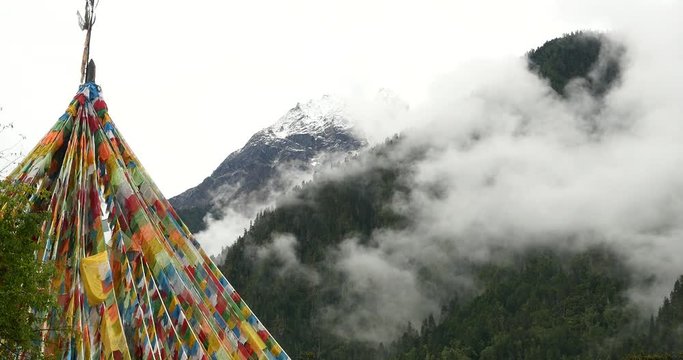 4k prayer flag with snow mountain in tibet.