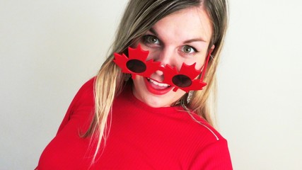 Happy young woman celebrating Canada Day, 150th Anniversary