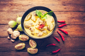 Thai food green curry chicken on wooden background. top view