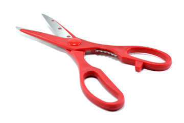 Red scissors on the white background