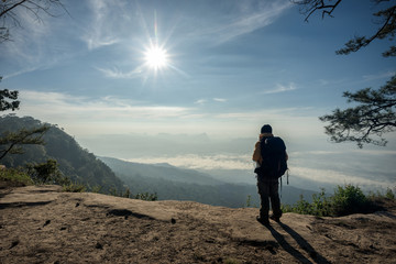 Man hikers tourist standing at the summit climber