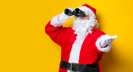 Funny Santa Claus holding binoculars