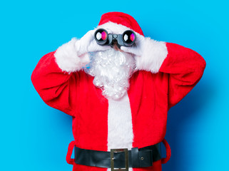 Funny Santa Claus have a fun with binoculars