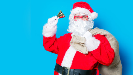 Fototapeta na wymiar Funny Santa Claus have a fun with bell