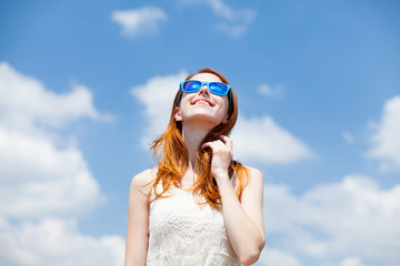 redhead girl in blue sunglasses
