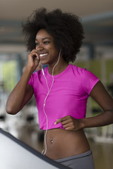 Fototapeta na wymiar afro american woman running on a treadmill