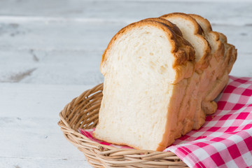 Fresh baked bread and sliced bread on rustic wooden table