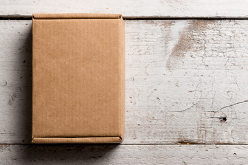 Cardboard box on a wooden background