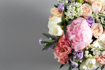 luxurious and elegant bouquet of roses and Other flowers. Composition colors on gray background. Copy space.