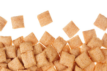 Golden pads corn flakes isolated with copy space background. Cereals texture.