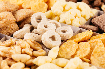 Corn flakes set closeup, decorative chess pattern. Cereals background.