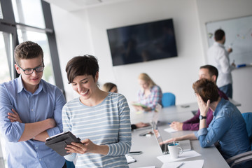 Fototapeta premium Two Business People Working With Tablet in office