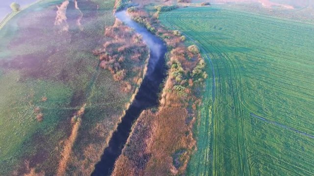 4K Aerial. Morning nature landscape with camera raising