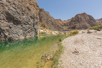 Water remaining from a flash flood in the Wadi Al-Arbaeen in Oman