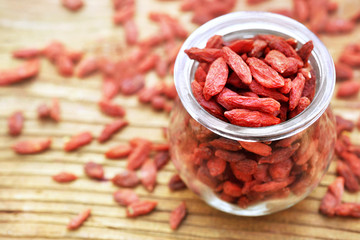 Glass bottle of dried goji berries, selective focus