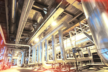 Equipment, cables and piping as found inside of a modern industrial power plant