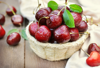 Sweet fresh cherries in wicker basket